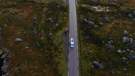 drone-flying-over-street-and-van-is-passing-under-it