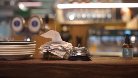 restaurant counter with receipts and service bell