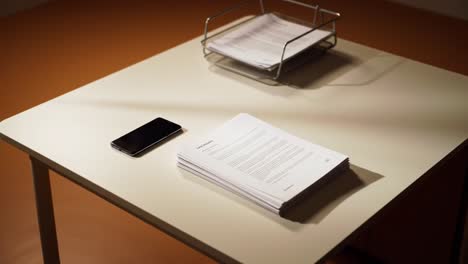 a well-organized workspace featuring documents and a smartphone, reflecting productivity and professionalism in a minimalist setting