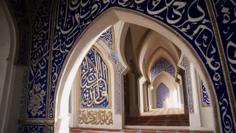 mosque interior with arabic calligraphy and blue patterns