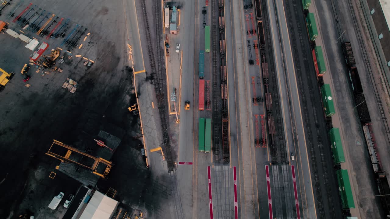 yellow yard jockey truck driving in a Intermodal Terminal Rail road with yard full of containers