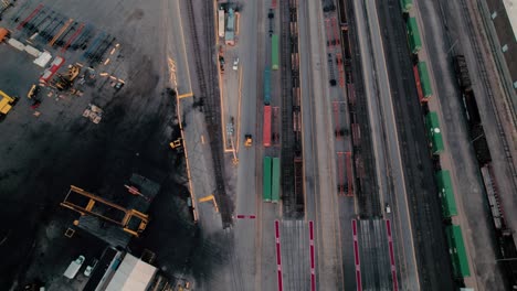 yellow yard jockey truck driving in a intermodal terminal rail road with yard full of containers