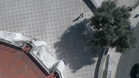 aerial, drone shot following the tourists walking over historic floor in chapel santo amaro of lisbon, on a misty and sunny morning, in portugal