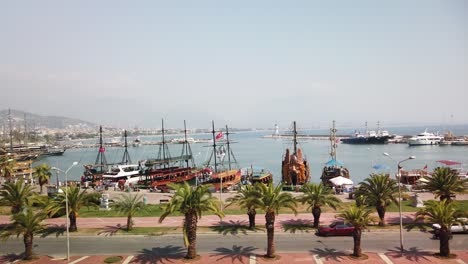 view of alanya and harbour at a sunny day. shore of mediterranean sea and historical alanya shipyard in turkey.