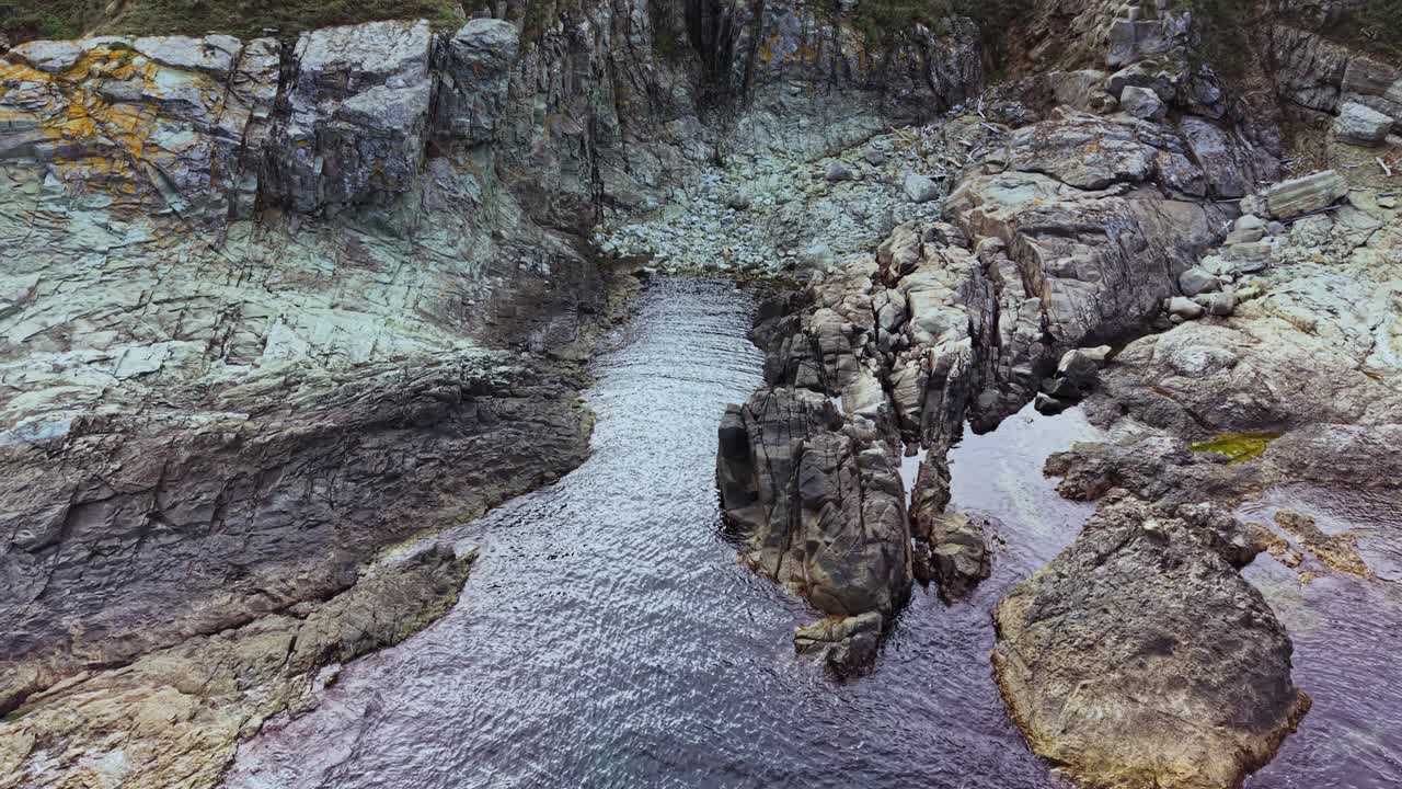 Dramatic rock formations and calm waters in a remote coastal area