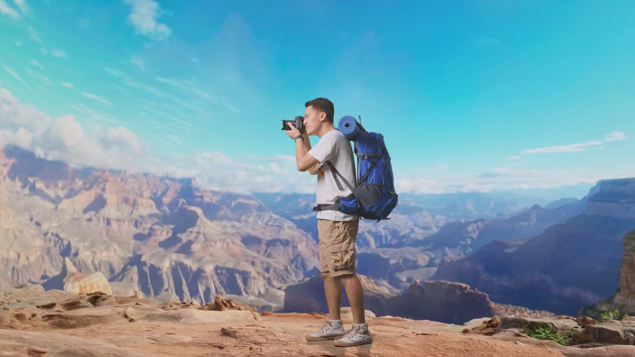 Full Body Side View Of Asian Male Hiker With Mountaineering Backpack Using A Camera Taking Picture While Traveling At The Top Of Mountain