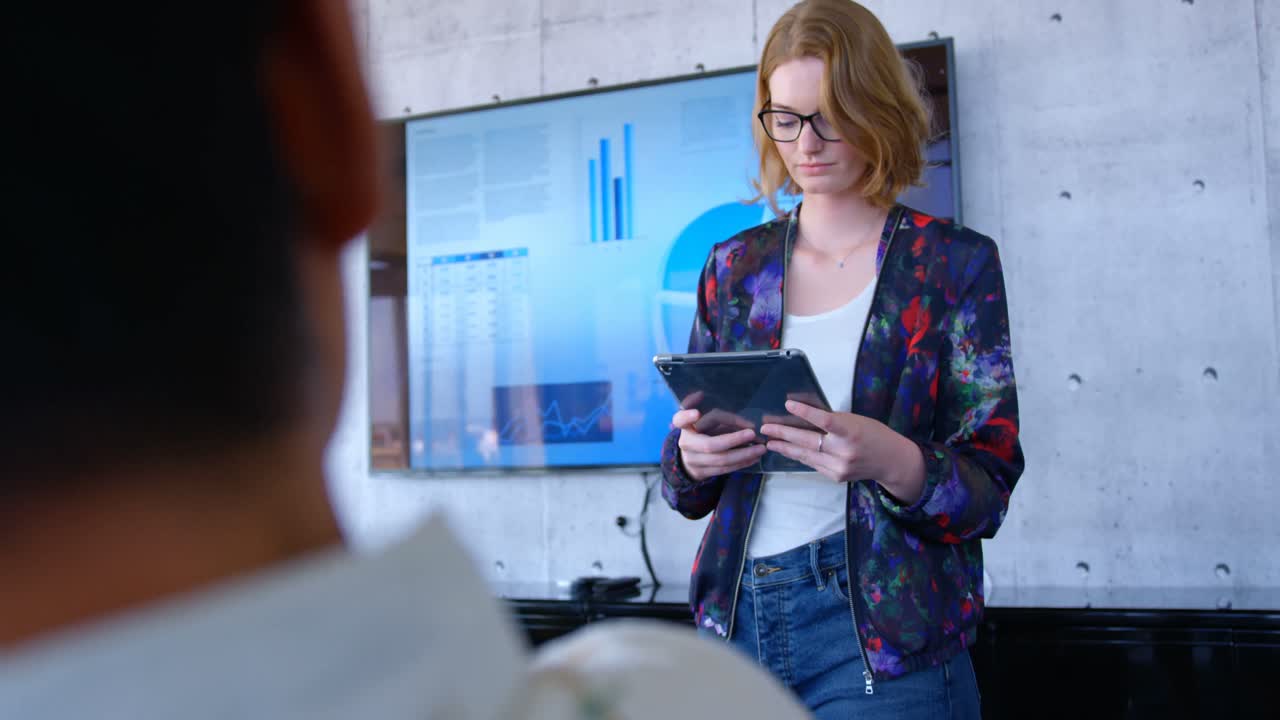 Pretty Caucasian businesswoman using digital tablet in modern office 4k