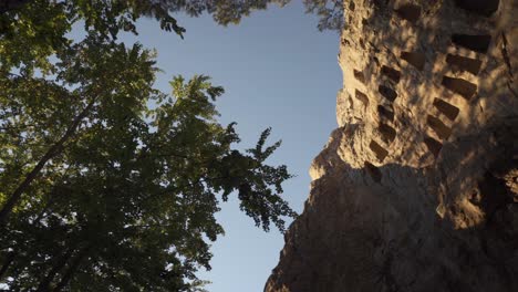 orbiting drone shot with an angle from the ground facing upwards of the eagle's rock or more commonly known as orlovi skali, a natural rock formation of religious significance in bulgaria