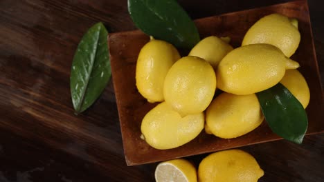 ripe lemons with leaves on a plate to slowly rotate.