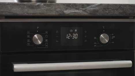 digital display on tabletop gas oven with grill shows settings including timer at 12:29, temperature control, and function modes, highlighting modern kitchen appliance interface and precise cooking setup