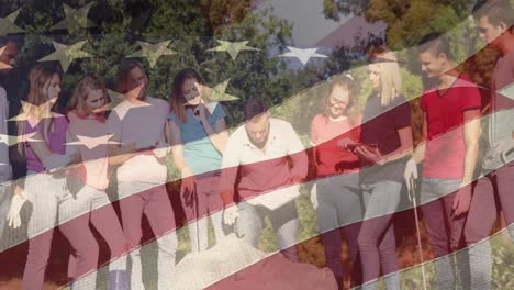 animation of flag of united states of america over diverse group of volunteers in park