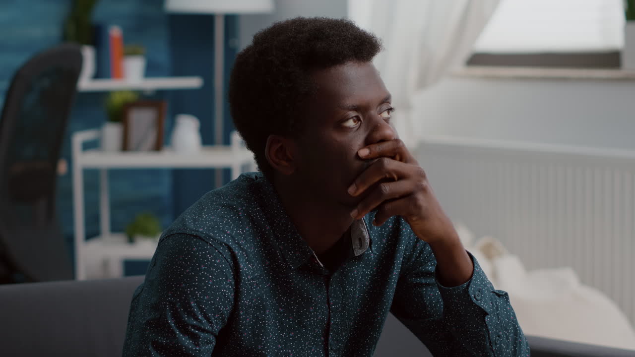 Portrait of pensive thoughtful authentic african american man looking out the window