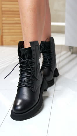 fashionable boutique of woman shoes. stylish footwear trying out in shop. vertical video
