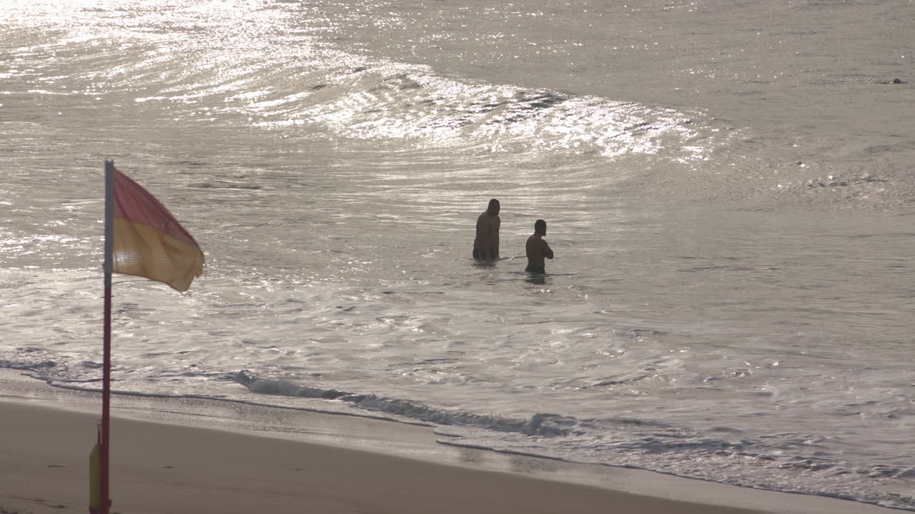 Two males swim in the early morning at Bondi Beach in Sydney Austalia
