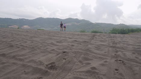 people running on a sand dune