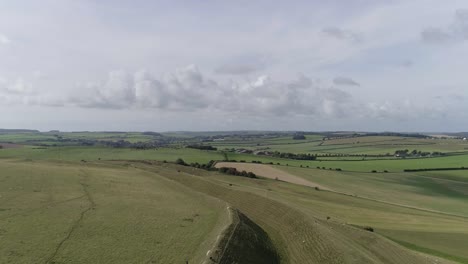 Aerial-tracking-slowly-west-above-the-northern-ramparts-of-Maiden-Castle
