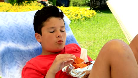 young boy eating chips