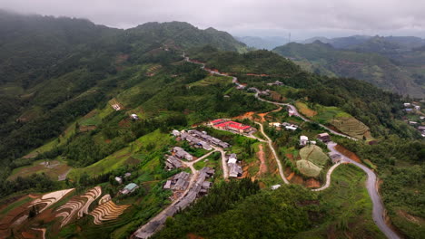 aerial view of a village in the mountains with rice terraces