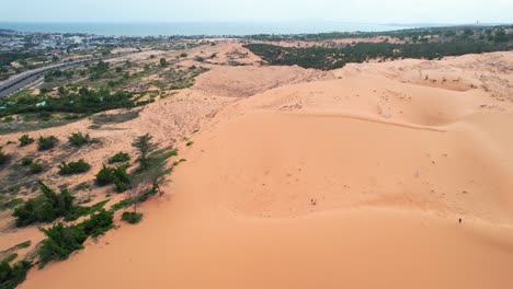 aerial circling a red desert sand dune along the coast of mui ne vietnam