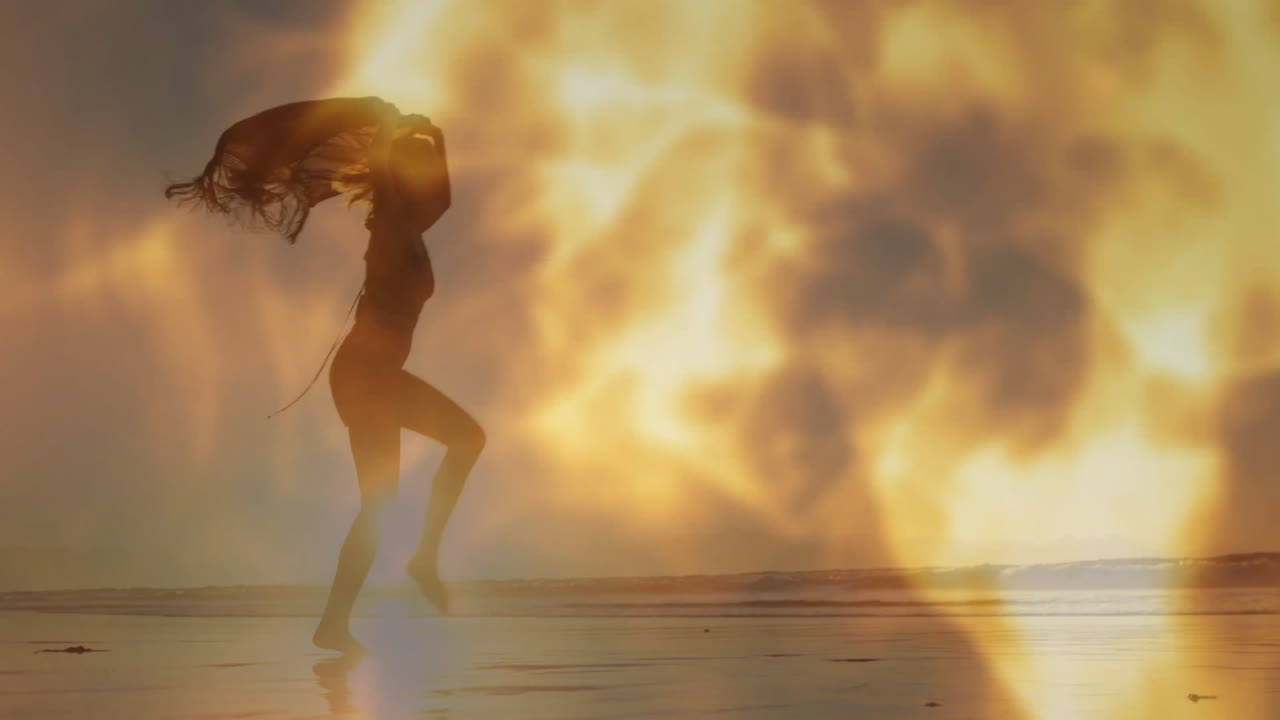 Running on beach, silhouette of person against fiery animation background