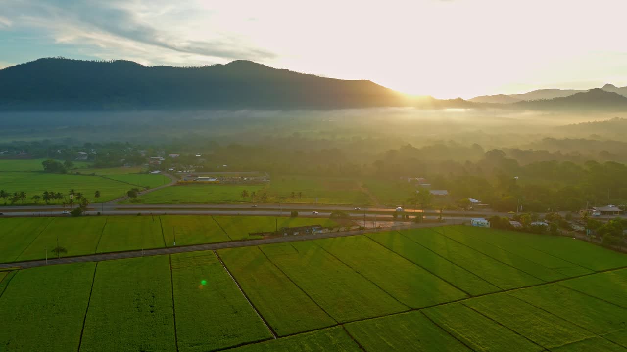 Sunset aerial view of Duarte highway running between vast farm lands