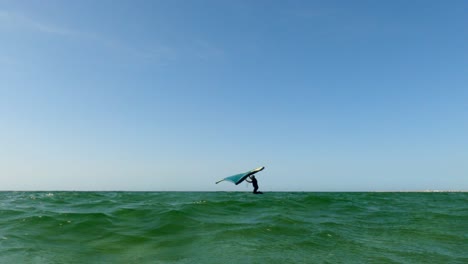 low angle pov of man on kite board wing surfing on sea surface