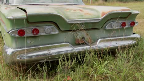 an old ford edsel sits in a field 7