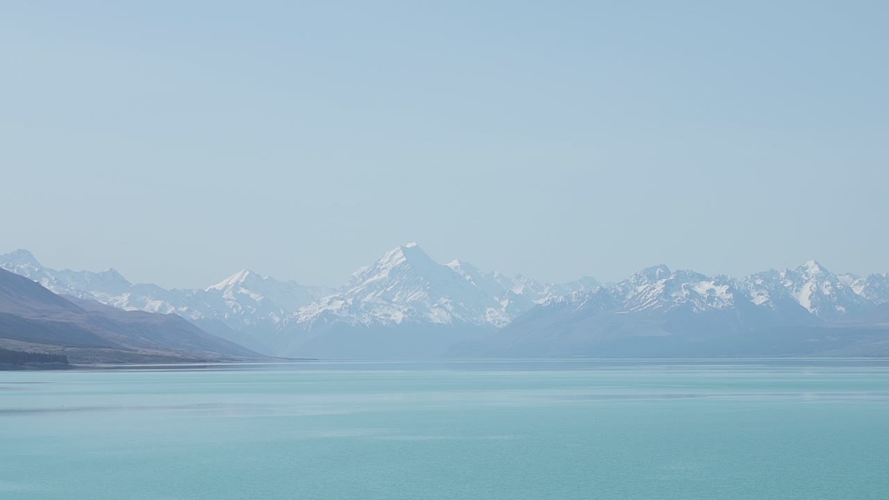 lake tekapo showing the snow peak in the disntance