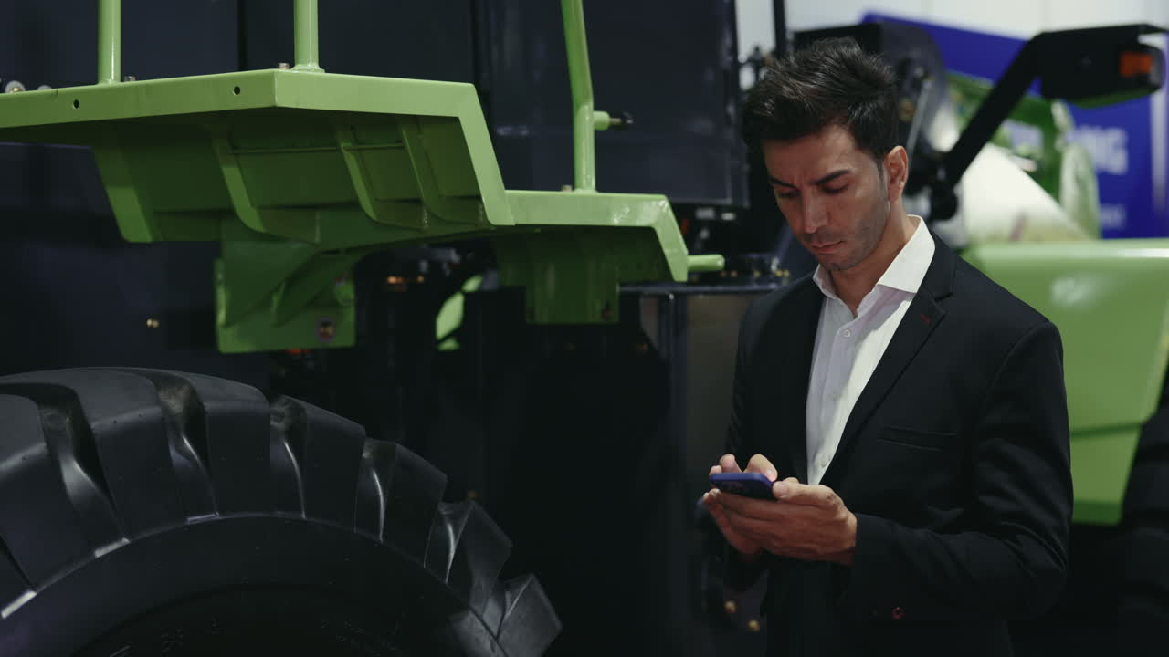 Businessman Inspecting Agricultural Machinery at Trade Show