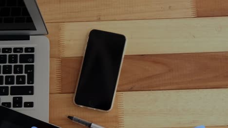 Animation-of-falling-school-backpacks-over-laptop-on-desk