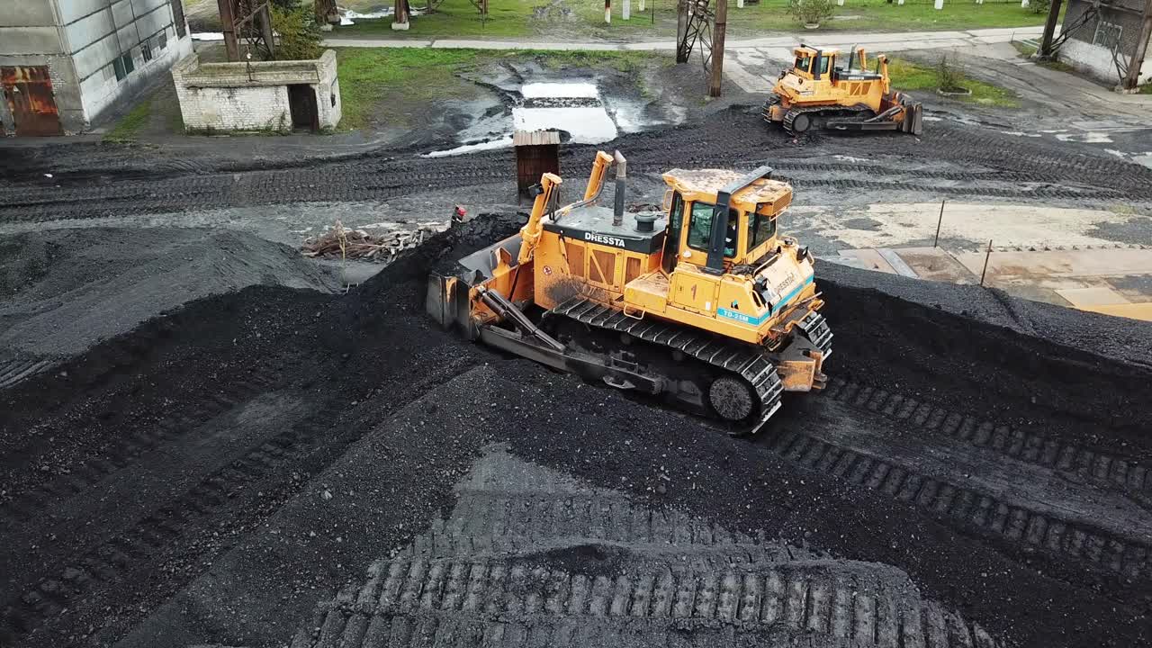 Crawler bulldozer works on coal mines. Energy for thermal power plants. Industry