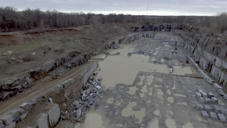 aerial shot over empty granite quarry mine