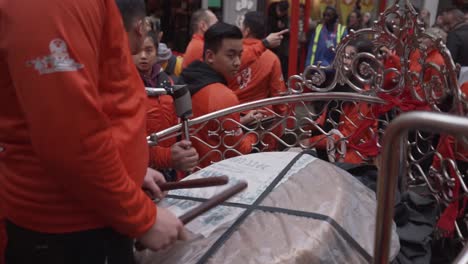 close view of a man playing the drum percusion making loud noise in chinese new year celebration in china town london england 2020