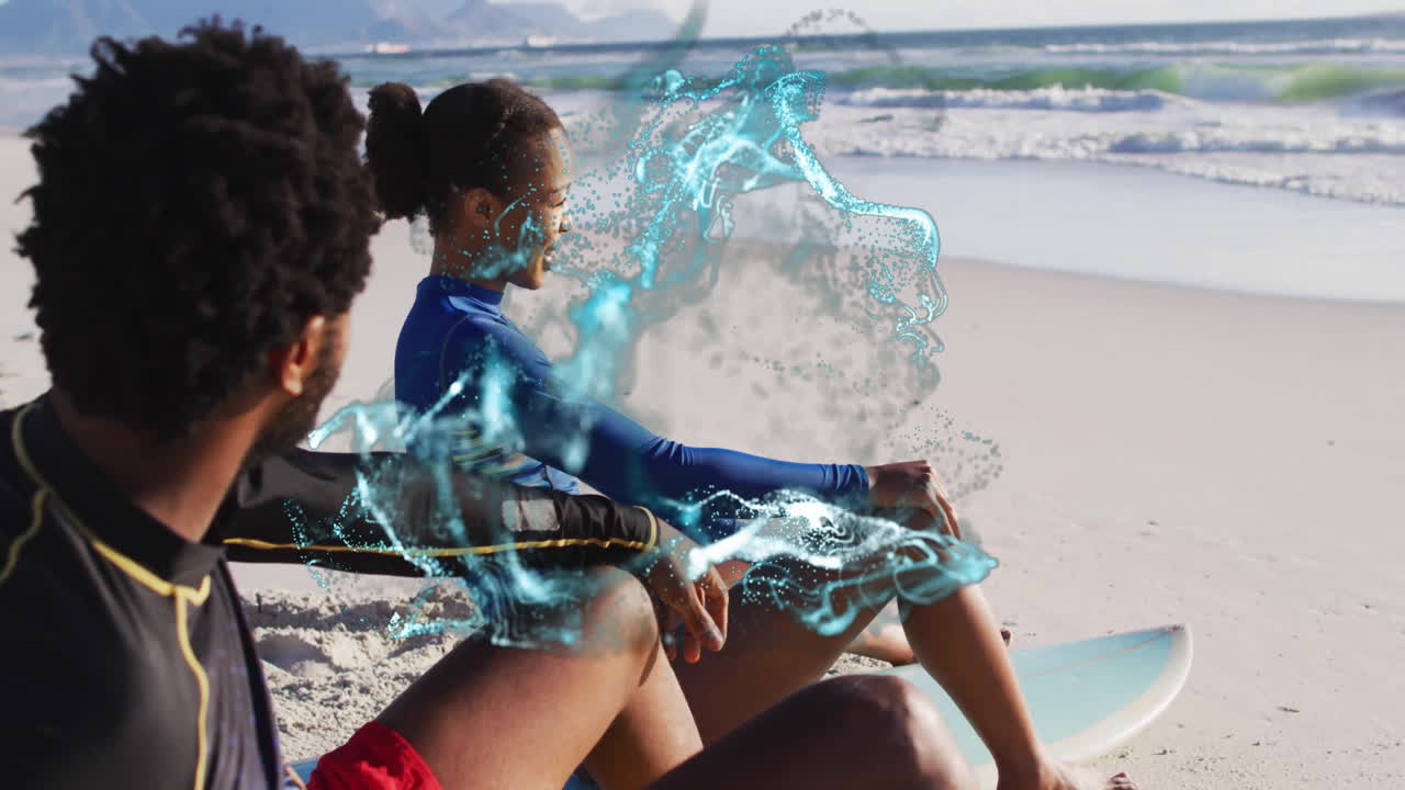Man and woman surfers sitting on surfboards at shoreline showing stylized technology splash overlay
