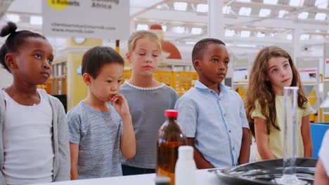 kids volunteering to answer teacher at a science centre