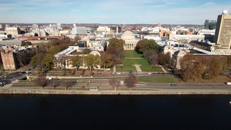 Aerial-of-MIT-over-the-Charles-River-and-Harvard-Bridge-in-Boston-Massachusetts,-Institute-of-Technology-during-clear-blue-sky-day