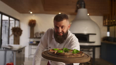 pizza cook man presenting traditional italian food recipe in restaurant kitchen.