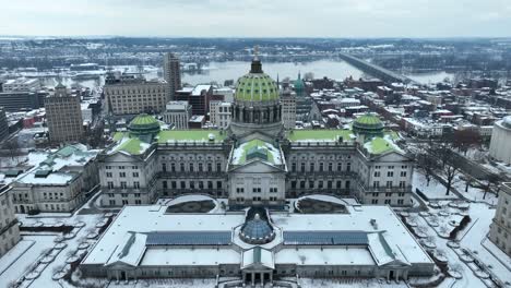 pennsylvania state capitol building during winter, covered in snow