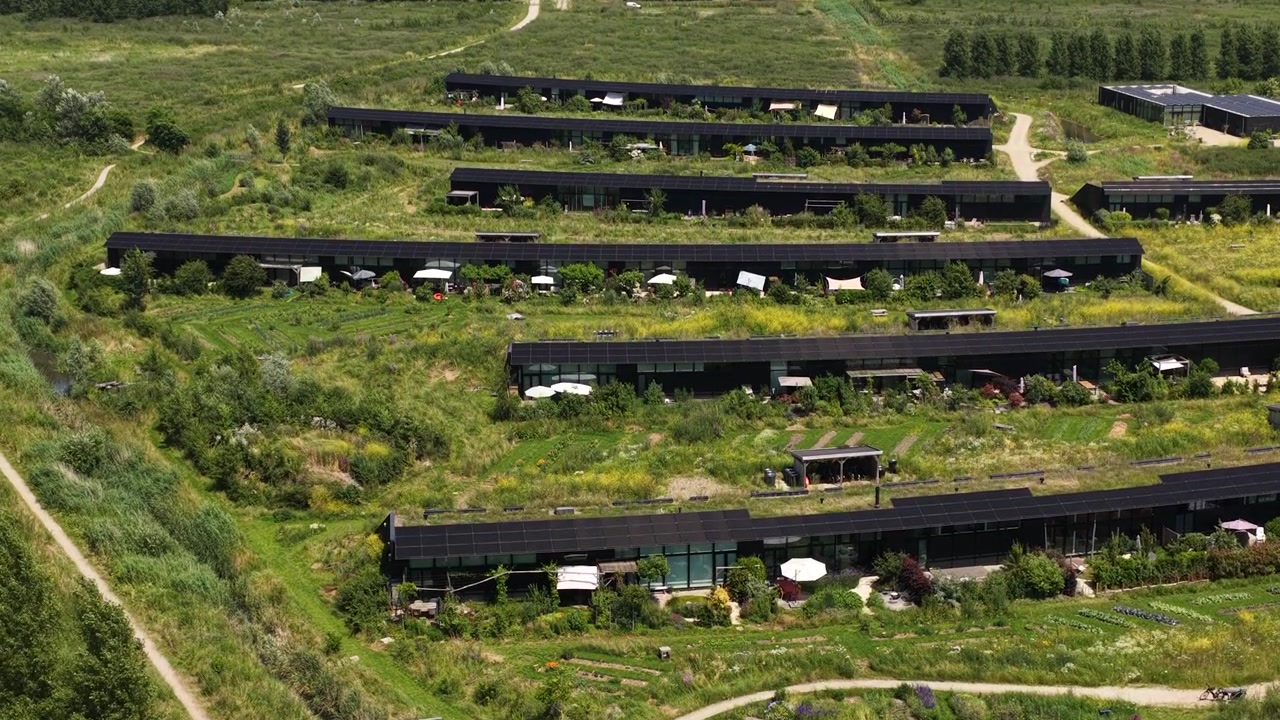 Aerial view of Ecovillage in Almere, the Netherlands, showing sustainable homes, biodiverse landscaping, nature inclusive architecture and climate adaptive residential design.