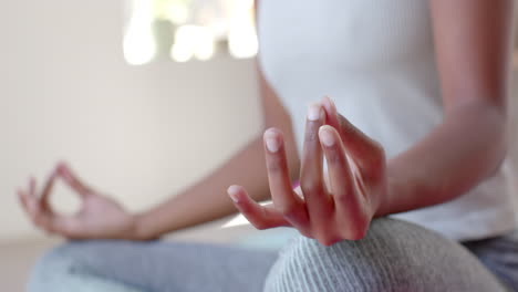 Focused-diverse-fitness-women-exercising-and-meditating-on-mat-in-white-room,-slow-motion