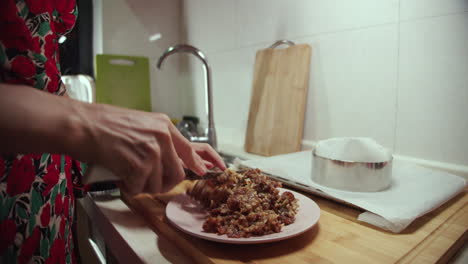 Woman-mashing-food-with-knife