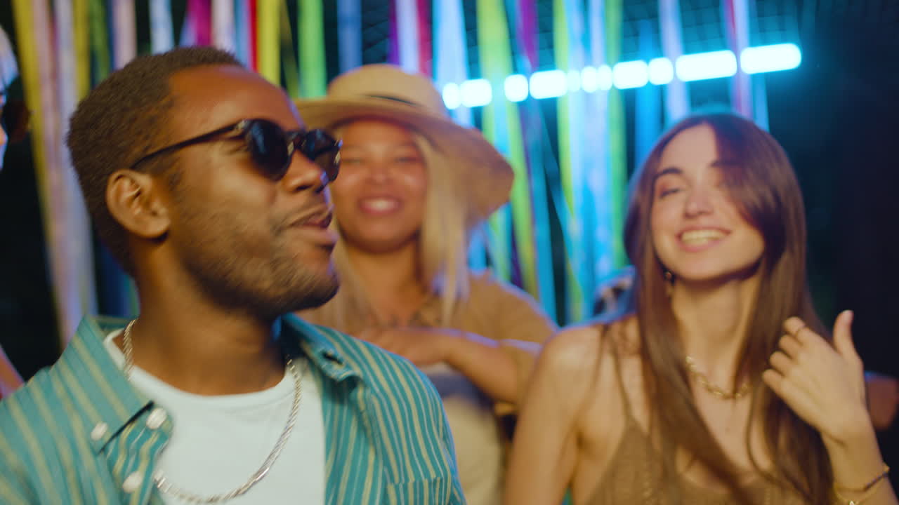 Friends dancing at night outdoors