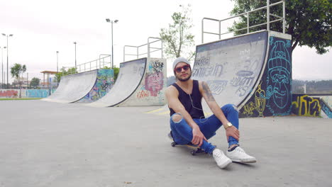 young boy using cell phone on a skate park