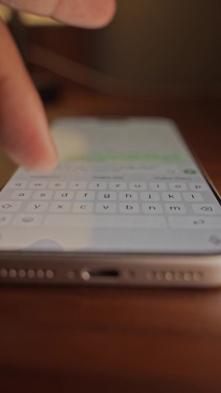 Man hands chatting and typing on smartphone macro closeup. Unrecognizable human typing text message tapping touchscreen keyboard using whatsapp application a social media.