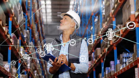 Animation-of-network-of-connections-with-icons-over-caucasian-male-worker-working-in-warehouse