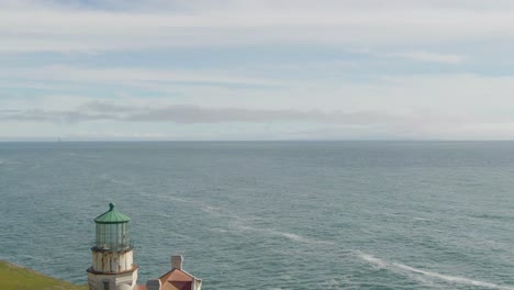 historic lighthouse on coast, drone reveal