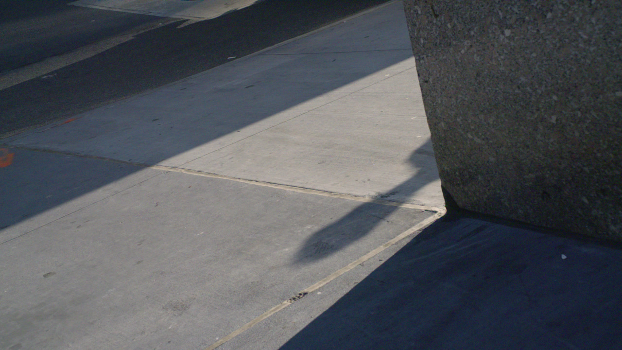 A shadow of a pedestrian in Midtown Manhattan. Shot on a summer morning in New York City.