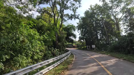 traveling down a winding road surrounded by nature