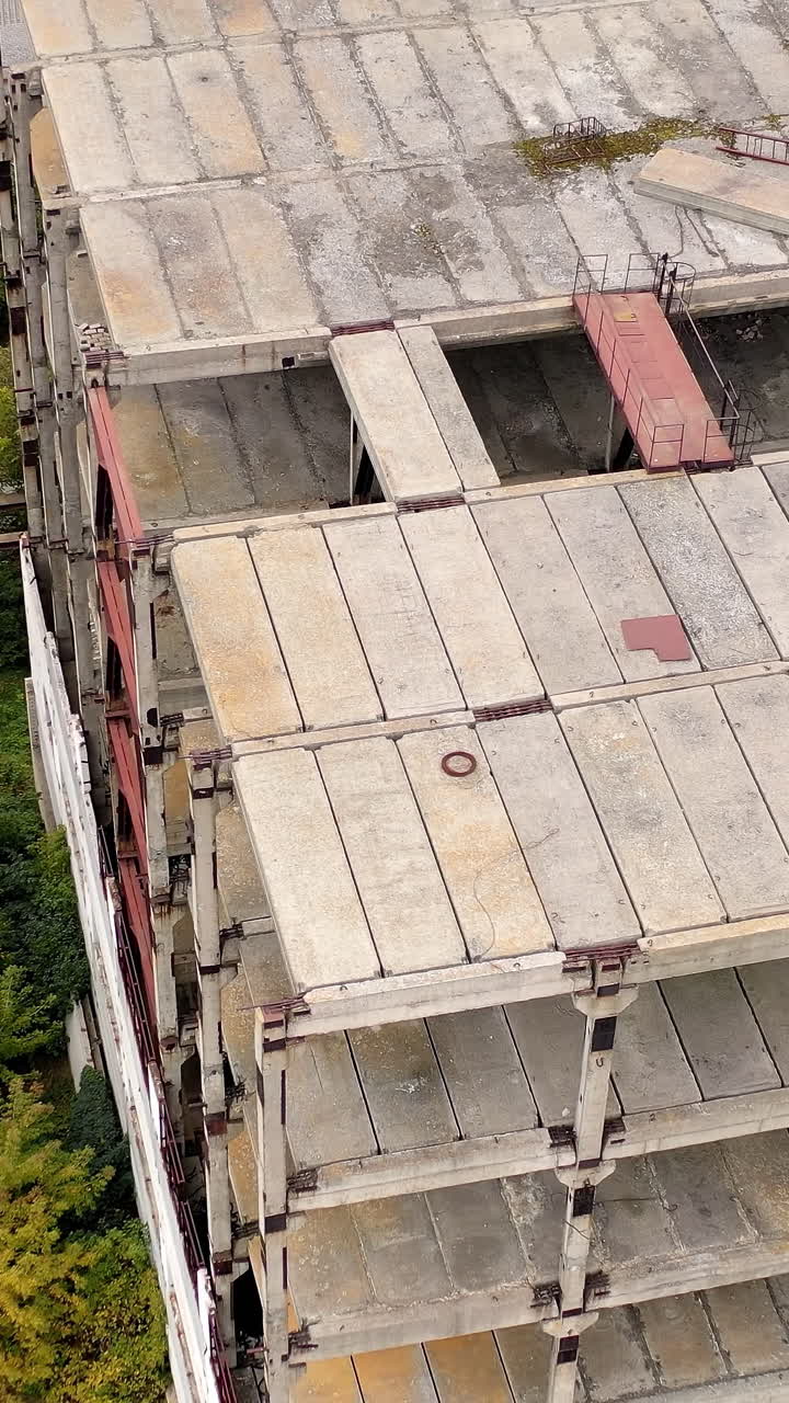 Ruined broken city construction industry. Old destroyed industrial building. Vertical video
