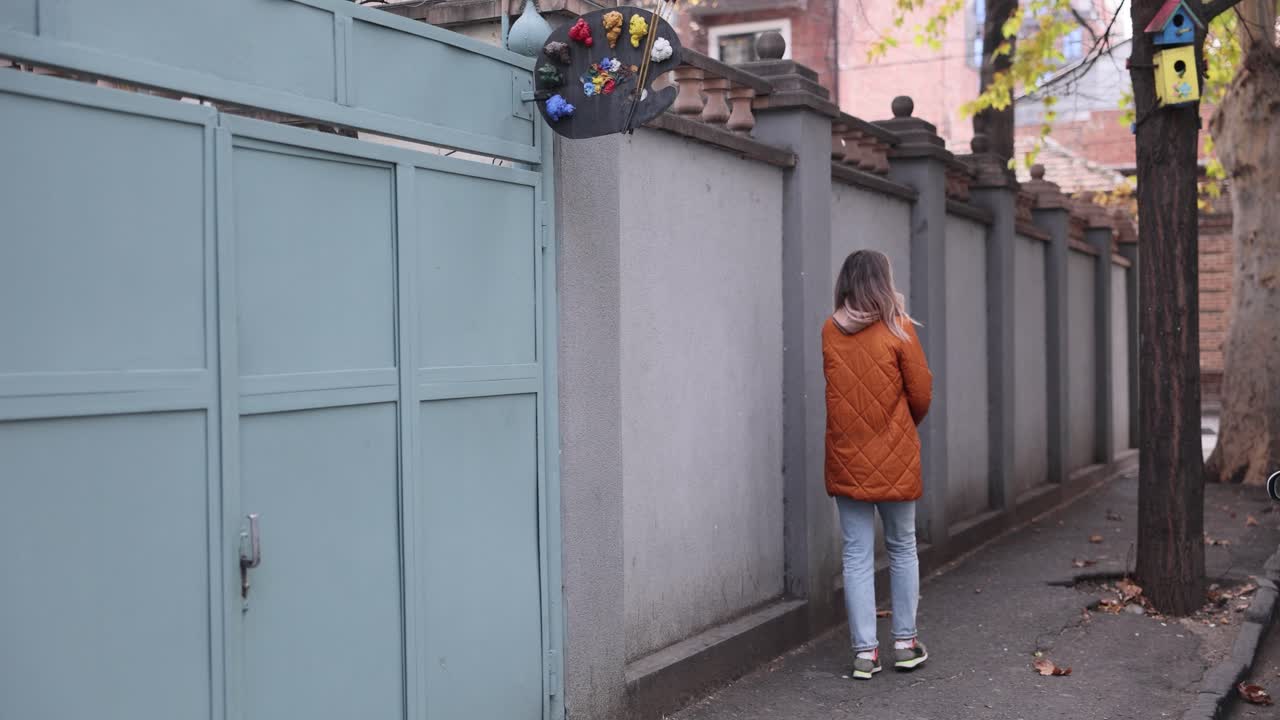 Woman walking along a city sidewalk
